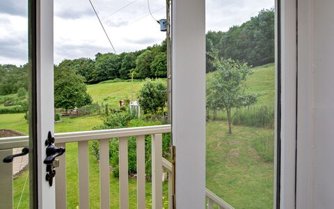 The Burrows: Porch, Hardwood, Wood Stain, Balcony, Baluster, Home Door, Shade, Handrail, Fence, Deck