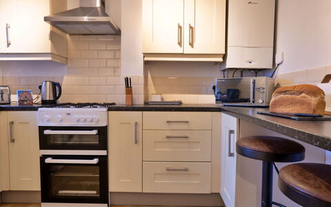 East Bank: Kitchen Appliance, Kitchen, Countertop, Furniture, Major Appliance, Cabinetry, Interior Design, Flooring, Kitchen Stove, Home Appliance