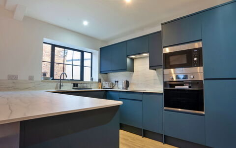 Courtyard View at Longford: Kitchen, Countertop, Cabinetry, Interior Design, Flooring, Kitchen Appliance, Major Appliance, Wood, Floor, Ceiling