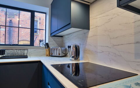 Courtyard View at Longford: Kitchen, Countertop, Kitchen Appliance, Interior Design, Flooring, Major Appliance, Cabinetry, Floor, Home Appliance, Kitchen Stove