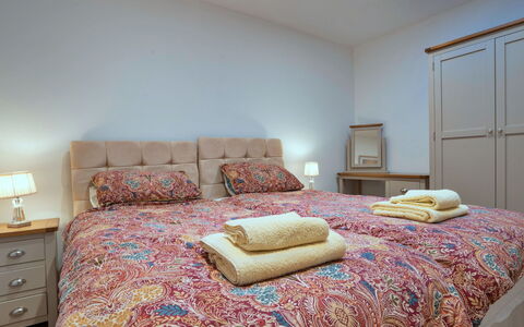 Courtyard View at Longford: Bed, Furniture, Bedding, Interior Design, Bedroom, Bed Sheet, Wall, Room, Floor, Wood