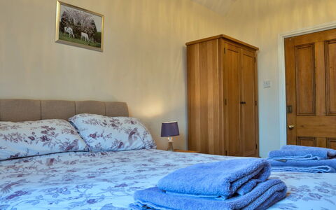 South Lodge at Longford: Bed, Furniture, Wall, Bedroom, Wood, Bed Sheet, Interior Design, Bedding, Floor, Flooring