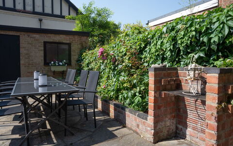House on the Green: Wall, Brick, Brickwork, Shrub, Garden, Backyard, Outdoor Furniture, Yard, Landscaping