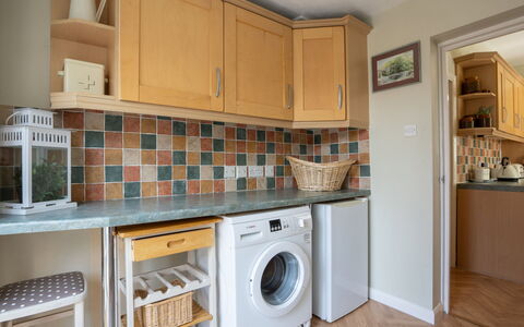 House on the Green: Washing Machine, Major Appliance, Kitchen Appliance, Kitchen, Countertop, Interior Design, Flooring, Laundry Room, Clothes Dryer, Floor