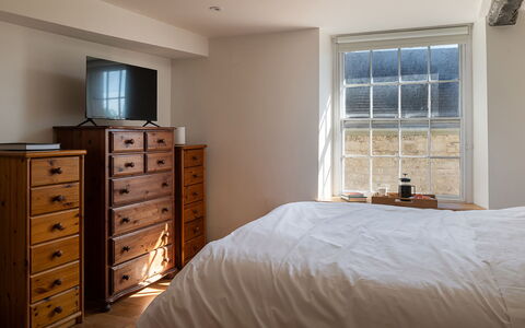 The Painswick Retreat: Bed, Bedroom, Furniture, Bedding, Bed Sheet, Wood, Interior Design, Flooring, Floor, Drawer