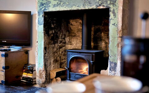 Flittermouse Cottage: Hearth, Furniture, Flooring, Interior Design, Stove, Room, Wood-Burning Stove, Heat, Fireplace, Living Room