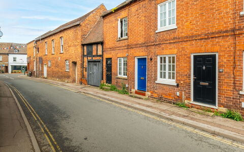 Three Storeys in Newent: Wall, Window, Building, Road Surface, Yellow, Brickwork, Road, Street, Brick, Neighbourhood