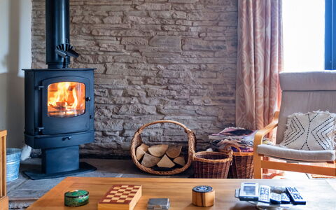 New Lodge Granary: Flooring, Furniture, Hearth, Living Room, Wood-Burning Stove, Heat, Wood Stain, Fireplace, Stone Wall