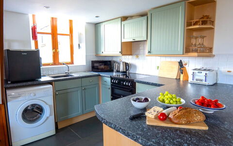Fields Barn at Widemouth Bay: Kitchen Appliance, Kitchen, Countertop, Major Appliance, Interior Design, Cabinetry, Flooring, Furniture, Kitchen Stove, Stove