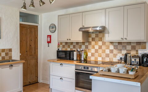 Swallow Cottage: Kitchen, Kitchen Appliance, Countertop, Cabinetry, Major Appliance, Wood, Flooring, Interior Design, Kitchen Stove, Furniture