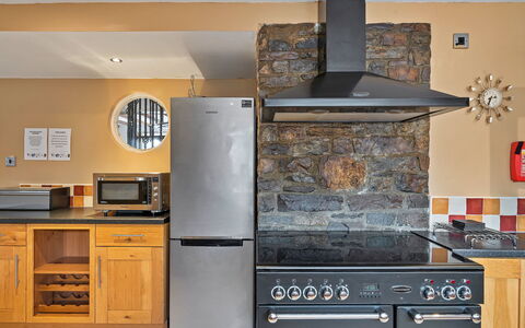 The Old School House at Instow: Kitchen Appliance, Kitchen, Furniture, Major Appliance, Cabinetry, Countertop, Flooring, Kitchen Stove, Home Appliance, Interior Design