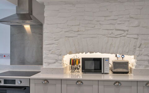 Hillside Rise: Interior Design, Kitchen, Ceiling, Countertop, Kitchen Appliance, Cabinetry, Natural Material, Stone Wall, Design, Home Appliance