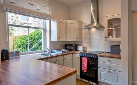 Captain'S Cottage at Mixtow Creek: Kitchen Appliance, Kitchen, Countertop, Interior Design, Cabinetry, Flooring, Major Appliance, Wall, Wood, Home Appliance