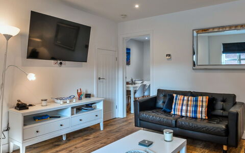 Salt & Stone: Furniture, Interior Design, Couch, Flooring, Television, Electronic Device, Room, Wood, Living Room, Floor