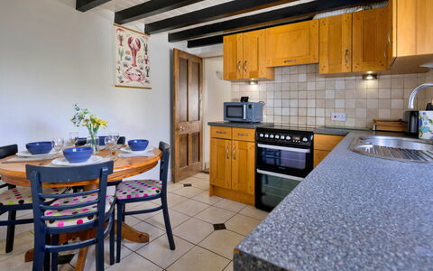 Penrhos Sea Cottage: Flooring, Furniture, Countertop, Interior Design, Kitchen, Floor, Cabinetry, Room, Tile, Ceiling