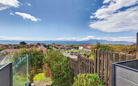 Seamill Beach House: Sky, Blue, Cloud, Residential Area, Suburb, Ocean, Cumulus, Coast, Landscaping, Meteorological Phenomenon