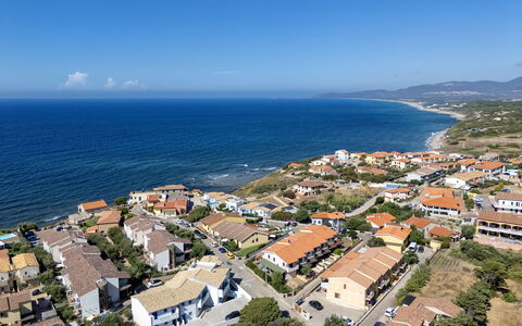 Perla Blu: Residential Area, Water, Building, Daytime, Body Of Water, House, City, Horizon, Coast, Summer