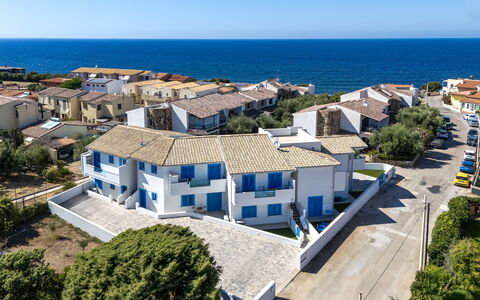 Perla Blu: Blue, Residential Area, Architecture, Home, Urban Design, Balcony, Sea, Suburb, Estate, Apartment