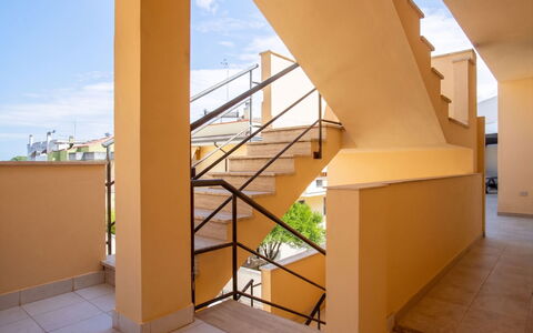 Mariposa: Handrail, Apartment, Balcony, Wood Stain, Daylighting, Stairs