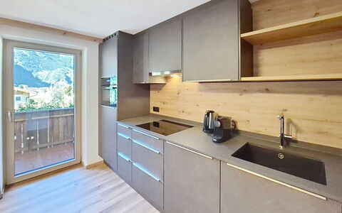 Mayrhofen 44: Kitchen, Flooring, Wood, Countertop, Interior Design, Cabinetry, Home, Floor, Home Appliance, Room