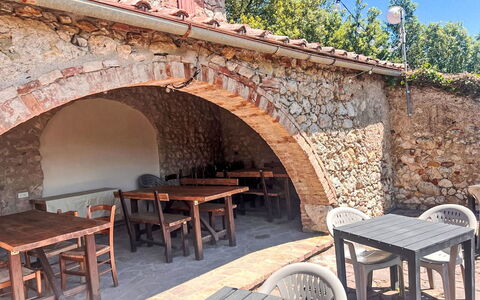 Villa Monti: Outdoor Table, Restaurant, Outdoor Furniture, Kitchen & Dining Room Table, Shade, Hacienda, Chair, Arcade, Patio, Stone Wall