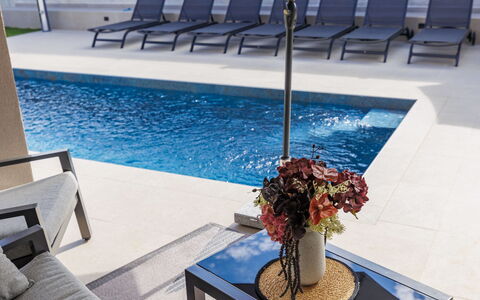 Veronica: Flooring, Floor, Furniture, Interior Design, Swimming Pool, Composite Material, Tile, Resort, Outdoor Furniture, Chair
