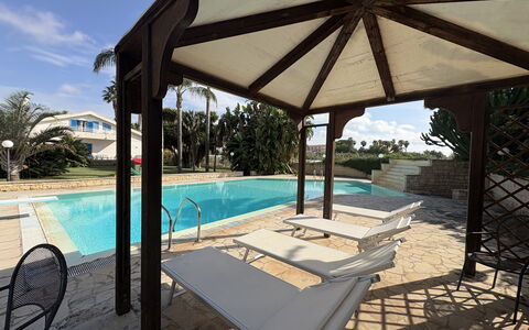 Villa le Palme, Marina di Ragusa: Swimming Pool, Resort, Shade, Gazebo, Composite Material, Outdoor Structure, Eco Hotel, Leisure, Pavilion, Outdoor Furniture