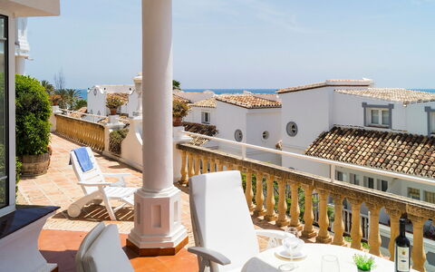 Mijas Beach: Sky, Furniture, Building, Tableware, Table, Plant, Chair, Seaside Resort, Outdoor Furniture, Shade
