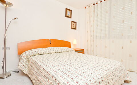 Edificio Nautic: Bedroom, Bed, Bed Sheet, Furniture, Bedding, Room, Property, Bed Frame, Wall, Orange