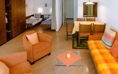 Ringstrasse Apt 126 900.24: Furniture, Property, Couch, Comfort, Orange, Living Room, Building, Table, Interior Design, Lighting