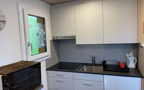 Margrith: Cabinetry, Property, Countertop, Drawer, Kitchen, Interior Design, Lighting, Kitchen Stove, Flooring, Chest Of Drawers