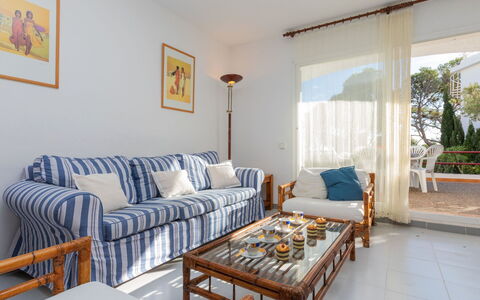 Residencial Cap de Grifeu: Table, Couch, Furniture, Property, Picture Frame, Window, Plant, Building, Comfort, Azure