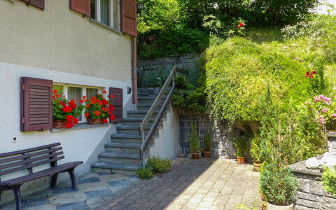 Grindelwald 104: Plant, Outdoor Bench, Flower, Building, Window, Road Surface, Flowerpot, Vegetation, Stairs, Urban Design