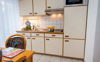 Dehne 100.3: Cabinetry, Countertop, Furniture, Sink, Kitchen Sink, Kitchen Stove, Kitchen, Wood, Lighting, Kitchen Appliance