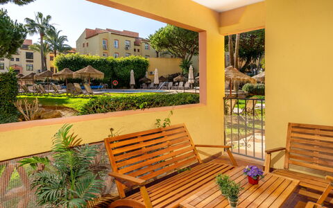 Dona Lola: Plant, Property, Furniture, Building, Outdoor Furniture, Shade, Sky, Wood, Interior Design, Grass