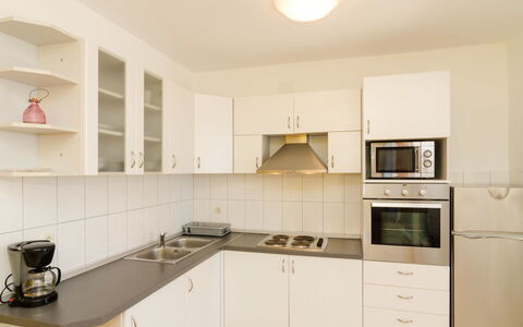 Trstenik Dingač 301: Property, Room, Kitchen, Cabinetry, Furniture, Countertop, Interior Design, Real Estate, Yellow, Building