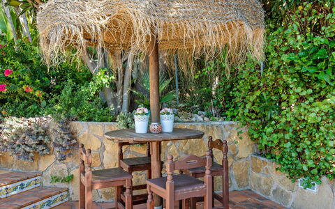 Petite Fleur: Outdoor Table, Furniture, Table, Botany, Grass Family, Tree, Outdoor Furniture, Thatching, Plant, House