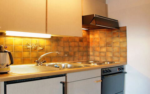 Leukerbad 550: Countertop, Cabinetry, Property, Kitchen, Room, Furniture, Sink, Lighting, Kitchen Stove, Yellow