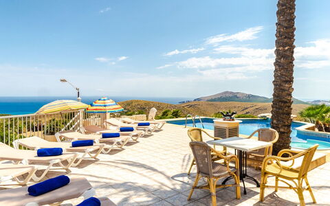 Cala Torta Na Lluny: Sky, Cloud, Table, Water, Furniture, Seaside Resort, Chair, Blue, Plant, Azure