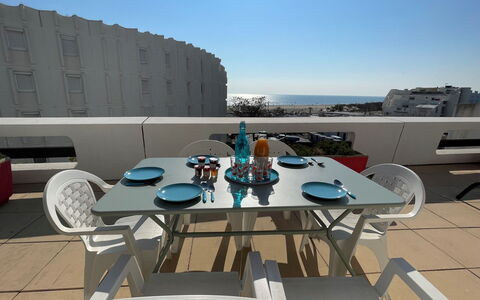 Jardins D'Ulysse Ii: Table, Sky, Furniture, Tableware, Chair, Building, Outdoor Furniture, Outdoor Table, Shade, Urban Design