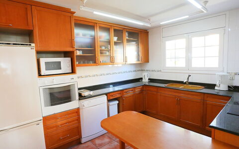 Villa Caleta: Countertop, Room, Property, Cabinetry, Kitchen, Furniture, Building, Orange, Interior Design, Kitchen Stove