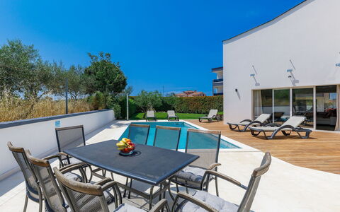 Lana: Table, Sky, Furniture, Chair, Azure, Outdoor Table, Outdoor Furniture, Shade, Swimming Pool, Building