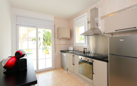 Requesens: Property, Room, Furniture, Kitchen, Countertop, Building, Interior Design, Cabinetry, Floor, Yellow