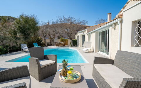 Villa du Littoral: Sky, Plant, Couch, Furniture, Property, Water, Building, Window, Flowerpot, Azure