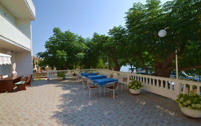 Rab Barbat 100: Sky, Plant, Property, Furniture, Building, Flowerpot, Table, Tree, Road Surface, Street Light