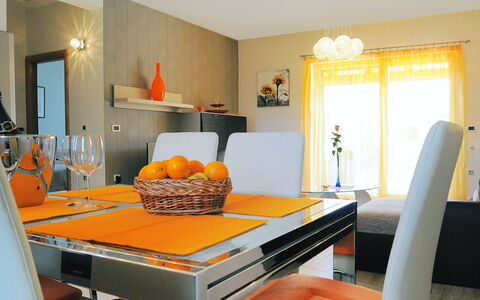 Lucija: Orange, Room, Furniture, Interior Design, Property, Yellow, Living Room, Ceiling, Table, Dining Room