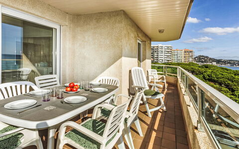 Blanes Beach: Table, Furniture, Property, Chair, Sky, Building, Wood, Cloud, Architecture, Shade