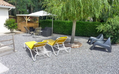 Sainte Marie: Plant, Property, Furniture, Tree, Shade, Outdoor Furniture, Grass, Road Surface, Chair, Building