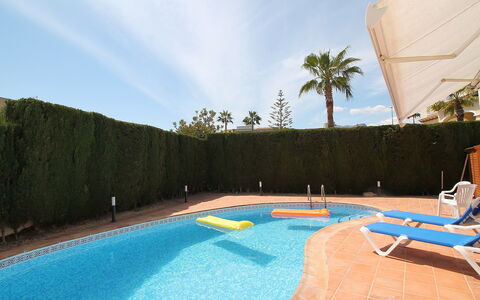 Leon: Water, Sky, Plant, Swimming Pool, Building, Azure, Shade, Tree, Body Of Water, Outdoor Furniture
