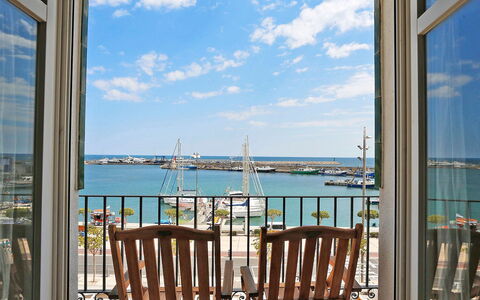 Cambrils Port: Sky, Cloud, Building, Water, Property, Blue, Porch, Azure, Chair, Wood